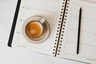 kaboompics_Coffee & Weekly Planner on Marble