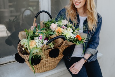 kaboompics_Young woman with basket full of flowers